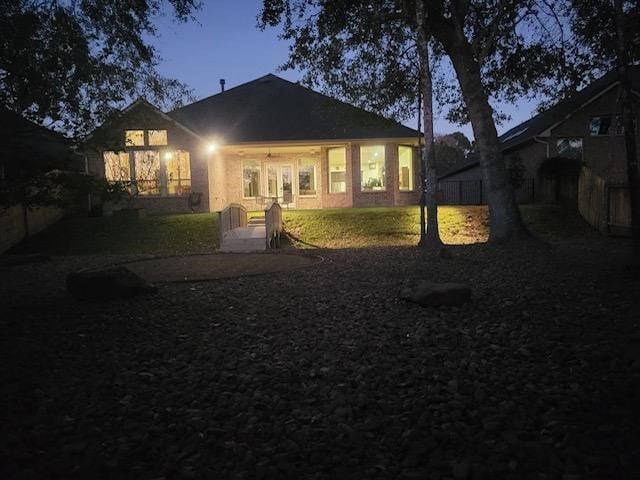 view of back house at dusk