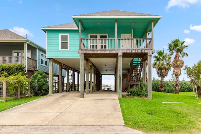 raised beach house with a carport and a front yard