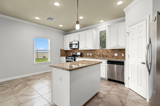 kitchen featuring white cabinets, a center island, appliances with stainless steel finishes, and pendant lighting