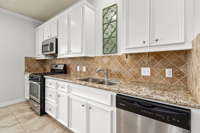 kitchen featuring crown molding, sink, tasteful backsplash, white cabinetry, and stainless steel appliances