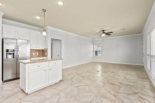 kitchen featuring stainless steel refrigerator with ice dispenser, light stone counters, ornamental molding, ceiling fan, and white cabinets