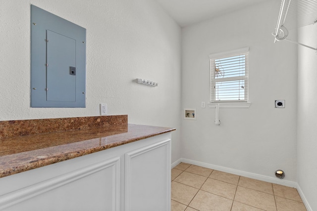 washroom featuring electric panel, hookup for a washing machine, light tile patterned flooring, and hookup for an electric dryer