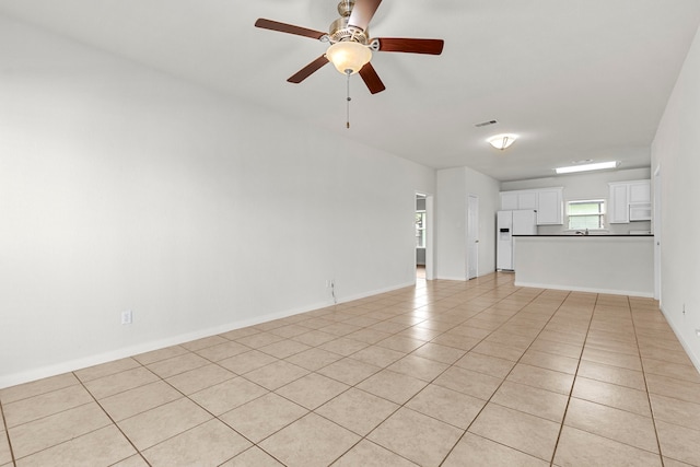 unfurnished living room featuring ceiling fan and light tile patterned floors