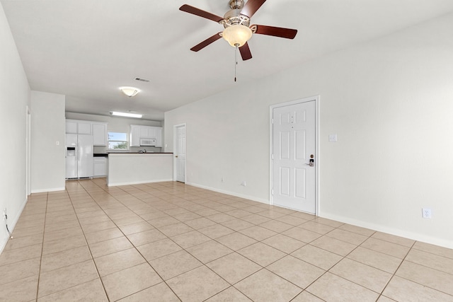 unfurnished living room featuring ceiling fan and light tile patterned flooring