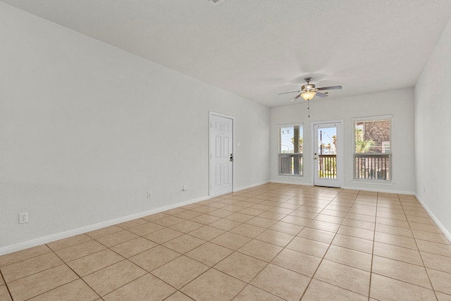 tiled spare room featuring ceiling fan