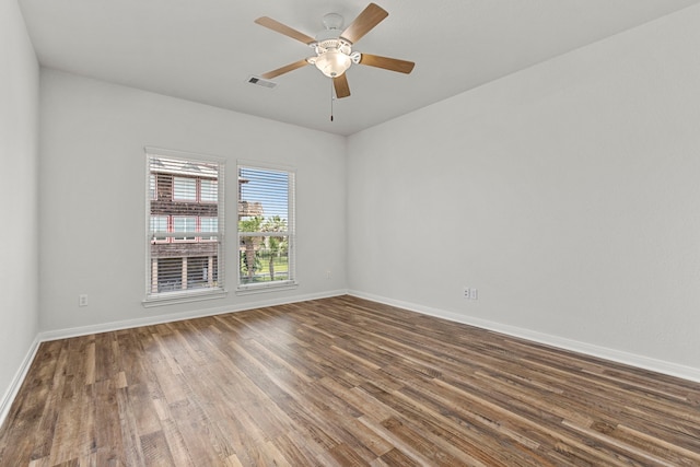 empty room with dark hardwood / wood-style floors and ceiling fan