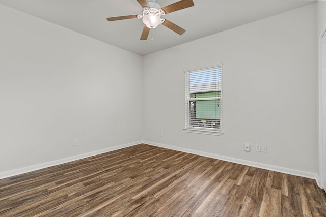 empty room with dark hardwood / wood-style flooring and ceiling fan