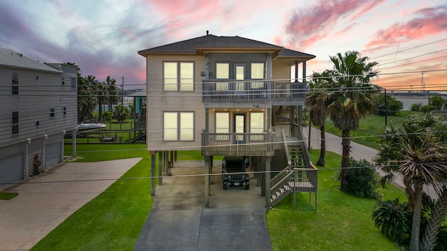 view of front of property featuring a lawn and a balcony