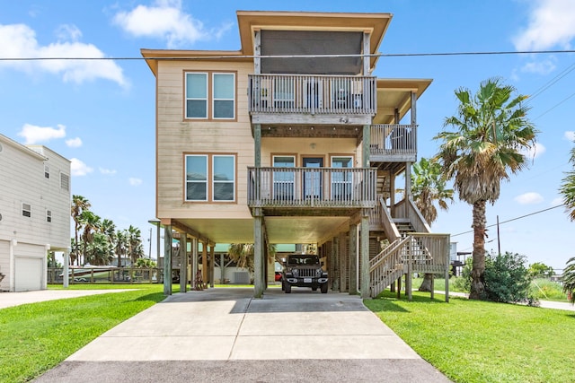 coastal home featuring a front lawn and a carport