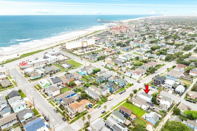 drone / aerial view with a beach view and a water view