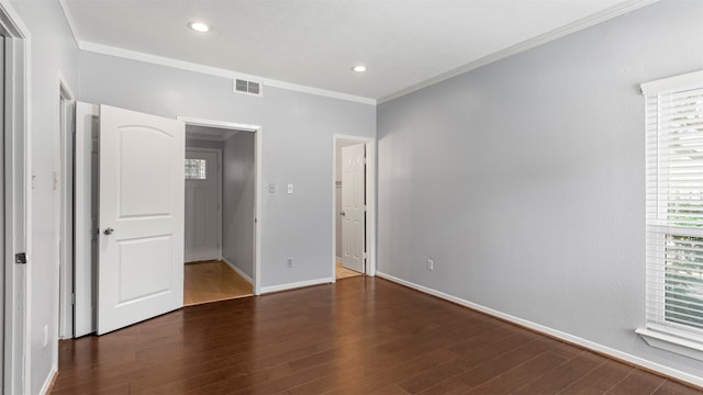 unfurnished bedroom featuring wood-type flooring and crown molding