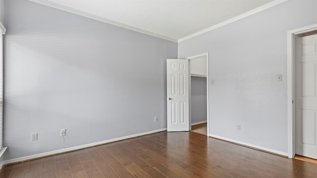 unfurnished bedroom featuring ornamental molding and dark hardwood / wood-style floors