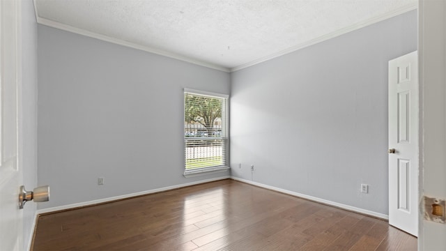 unfurnished room featuring dark wood-type flooring, ornamental molding, and a textured ceiling