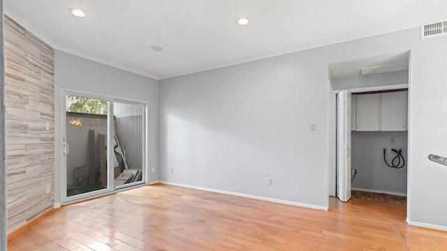 unfurnished room featuring light hardwood / wood-style floors and ornamental molding