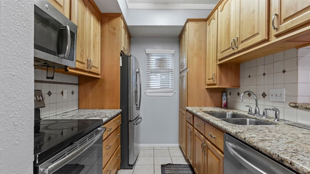 kitchen with sink, light tile flooring, backsplash, and appliances with stainless steel finishes