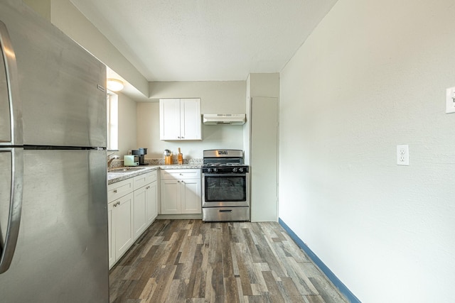 kitchen featuring sink, dark wood-type flooring, a textured ceiling, white cabinets, and appliances with stainless steel finishes