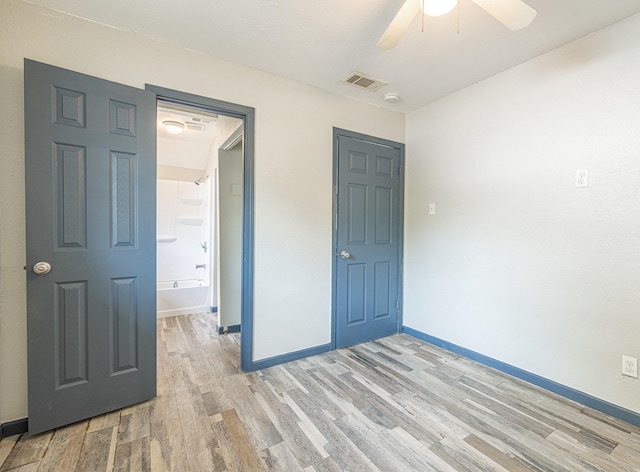 unfurnished bedroom with ceiling fan and light hardwood / wood-style floors