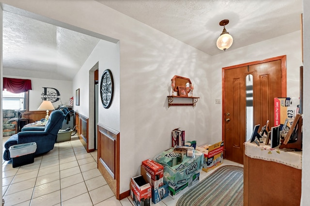 tiled foyer featuring a textured ceiling