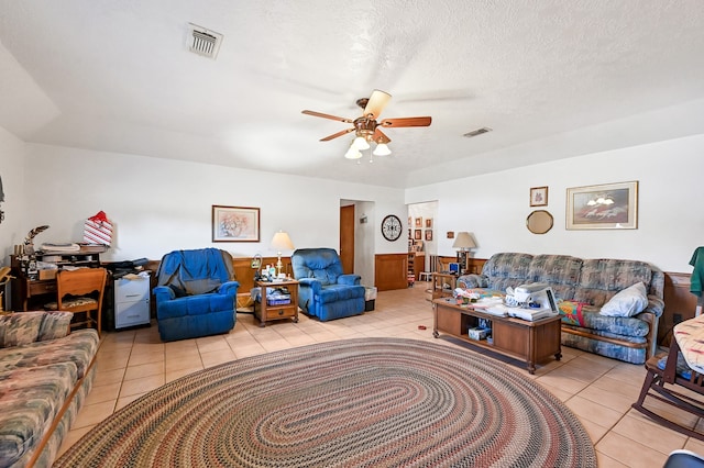 tiled living room featuring ceiling fan and a textured ceiling