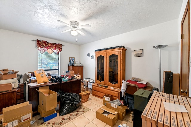 tiled home office with ceiling fan and a textured ceiling