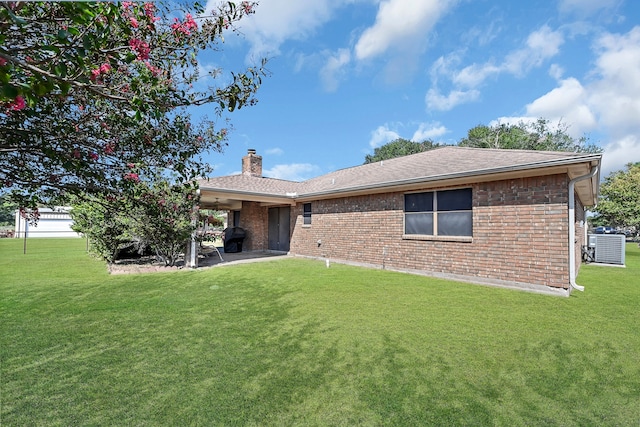 rear view of house with a yard and a patio area