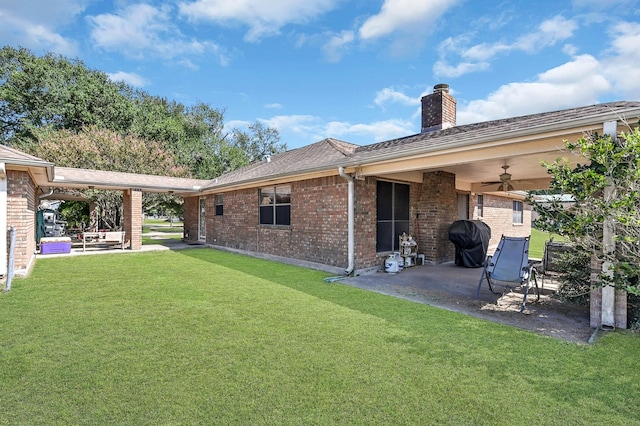 20003 Bauer Hockley Rd, Tomball, TX 77377 - rear view of house featuring a chimney, a yard, ceiling fan, a patio, and brick siding