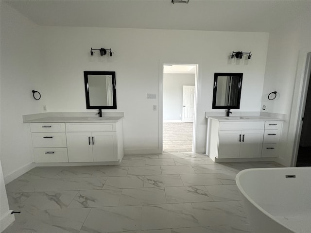 bathroom with vanity and a bath