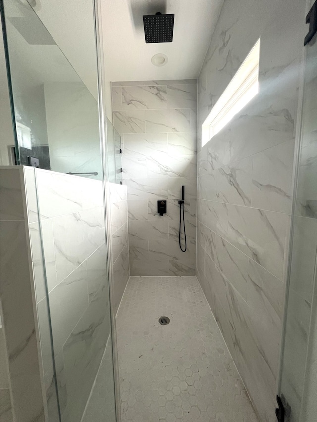 bathroom with a shower with shower door