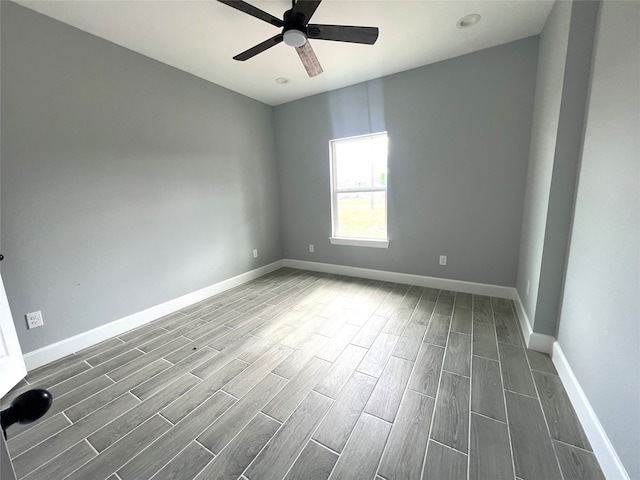 empty room with dark hardwood / wood-style floors and ceiling fan