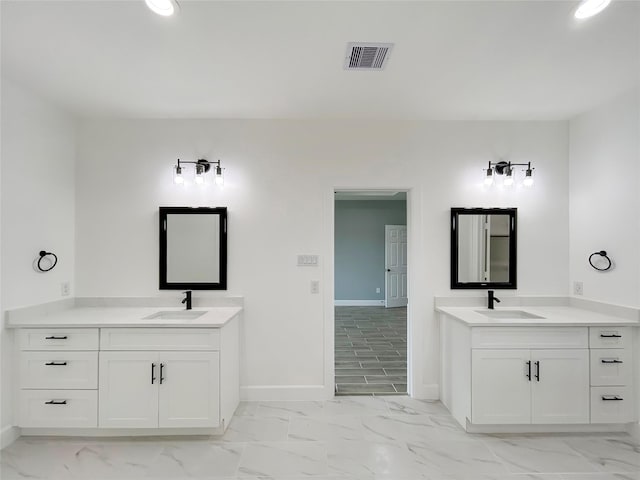 bathroom featuring marble finish floor, a sink, and visible vents