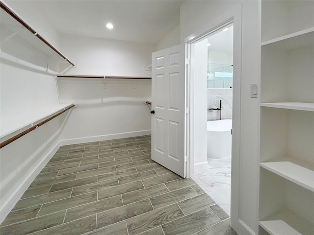 spacious closet with wood finish floors