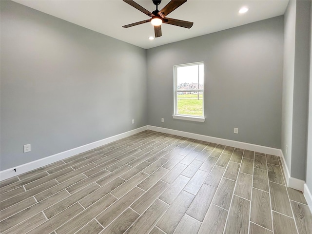 spare room featuring wood tiled floor, ceiling fan, baseboards, and recessed lighting