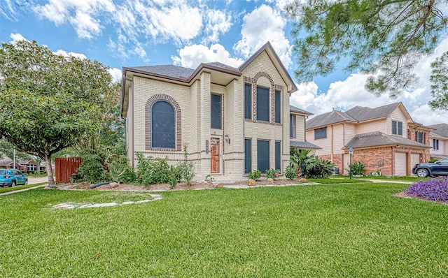 view of front of house with a front yard and a garage