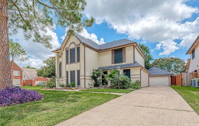 view of property featuring a front yard, a garage, an outdoor structure, and central AC unit