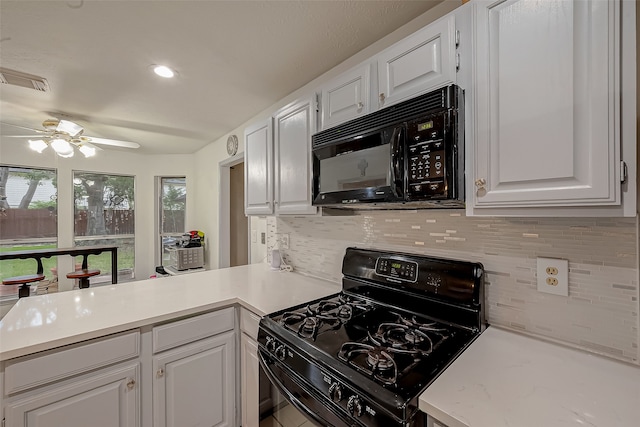 kitchen with ceiling fan, black appliances, decorative backsplash, and white cabinetry