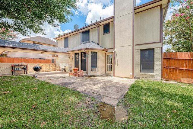 rear view of house featuring a patio and a yard