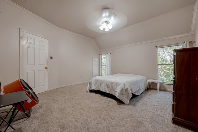 bedroom featuring multiple windows, vaulted ceiling, and light colored carpet