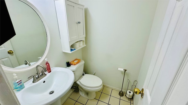 bathroom featuring tile patterned floors, toilet, and sink