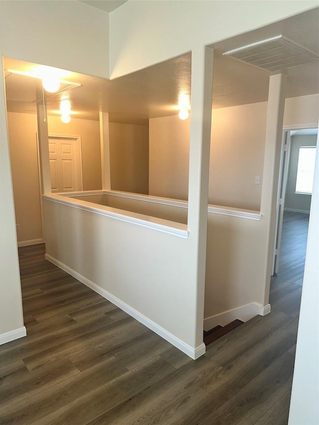 hallway with dark hardwood / wood-style floors