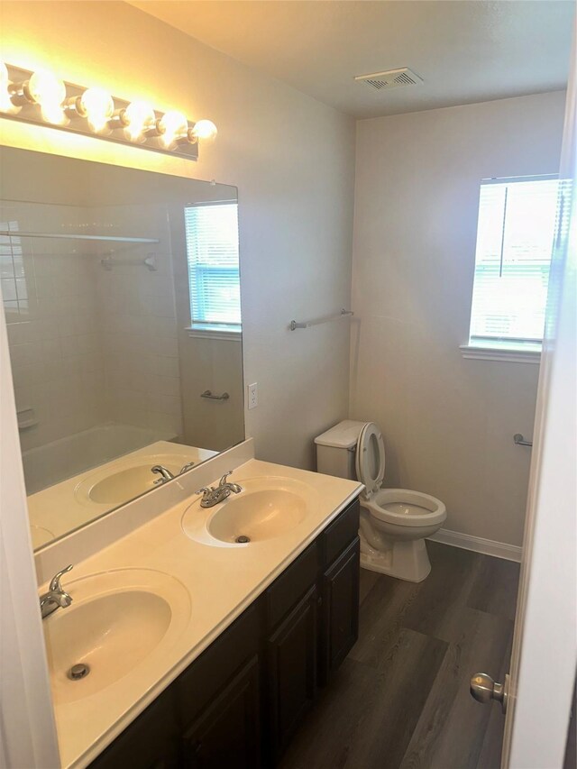 bathroom featuring hardwood / wood-style flooring, vanity, and toilet