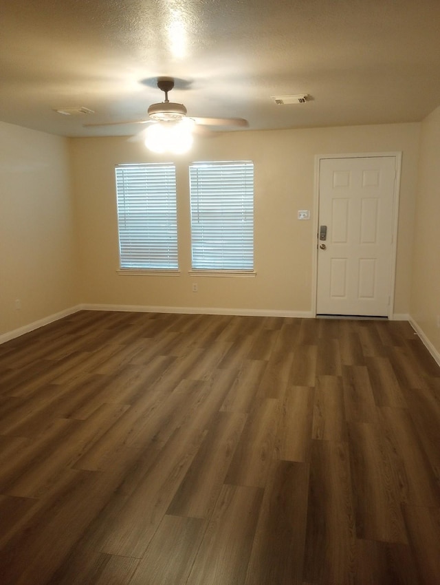 entryway featuring a textured ceiling, dark hardwood / wood-style flooring, and ceiling fan