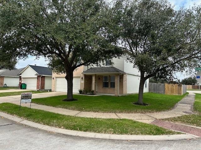 view of front facade with a garage and a front lawn