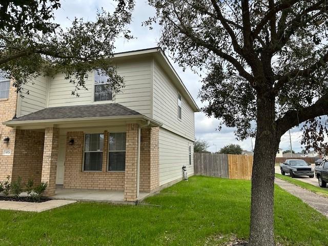 view of side of home with a yard