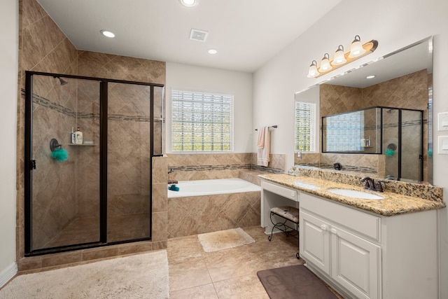 bathroom featuring tile flooring, separate shower and tub, and vanity