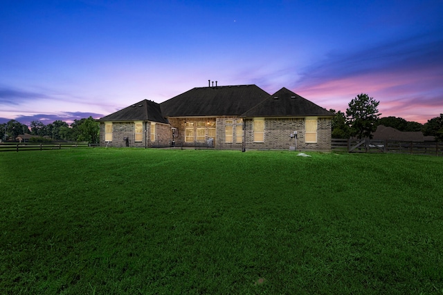 french country style house with a yard