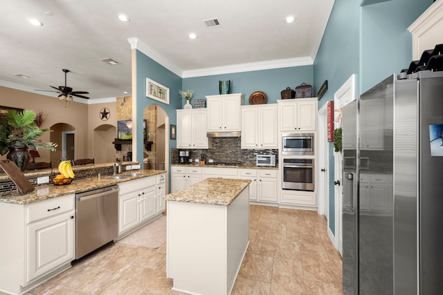 kitchen with light stone countertops, light tile flooring, kitchen peninsula, and stainless steel appliances