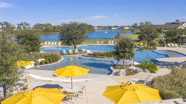 view of swimming pool with a patio and a water view