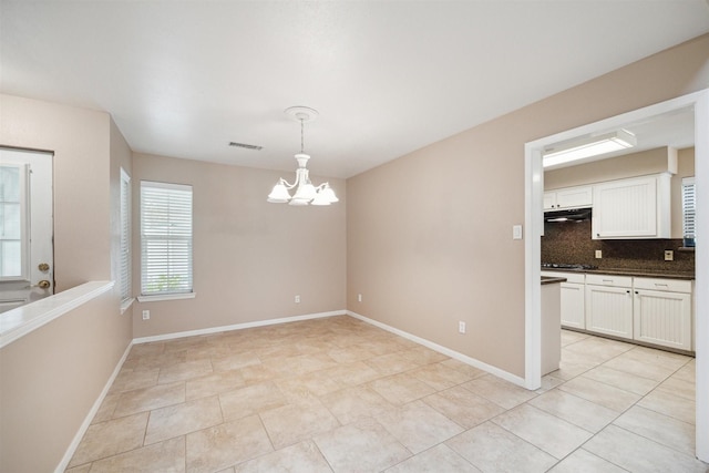 510 Brazos Hill Ln, Sealy, TX 77474 - unfurnished dining area featuring a chandelier and light tile patterned floors