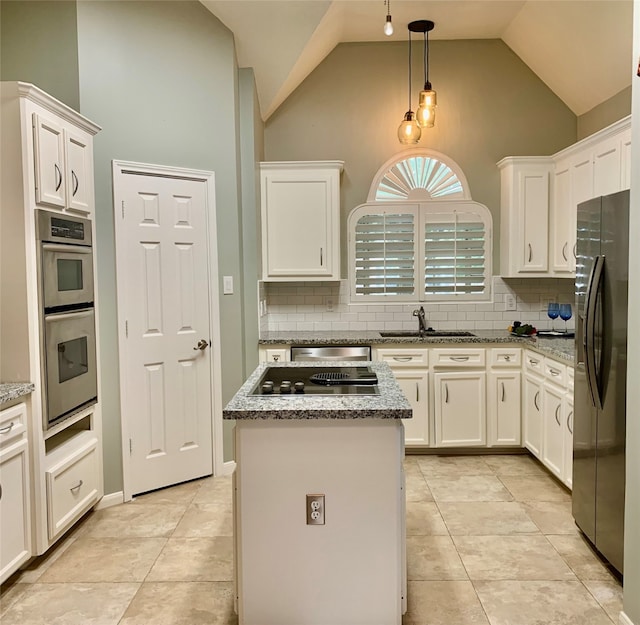 kitchen featuring sink, black appliances, high vaulted ceiling, white cabinets, and a center island