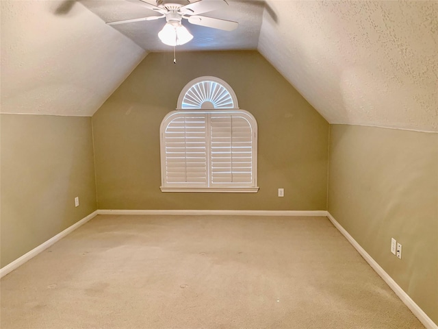 bonus room with carpet, a textured ceiling, ceiling fan, and lofted ceiling